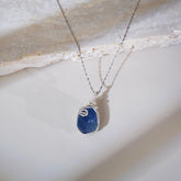 Handmade blue fluorite healing necklace on soft linen background
